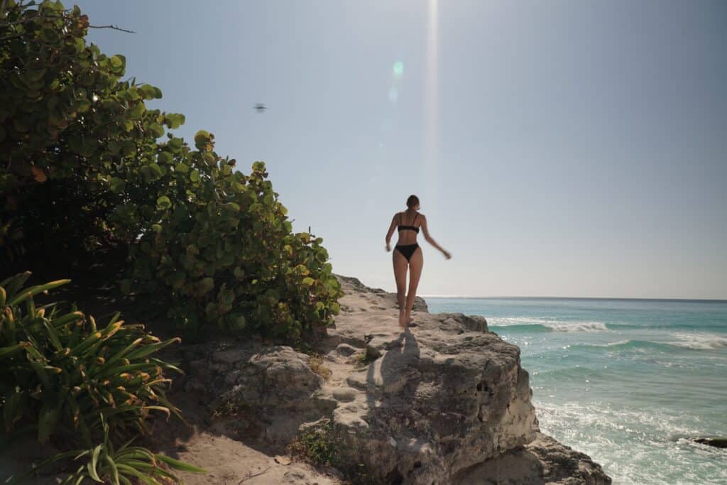 Standing on the rocky coastline in Cancun, Mexico