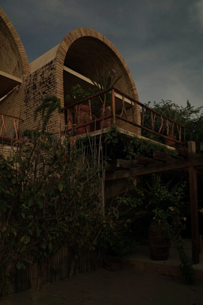 Brick vault terrace wrapped in plants at Casona Sforza Puerto Escondido