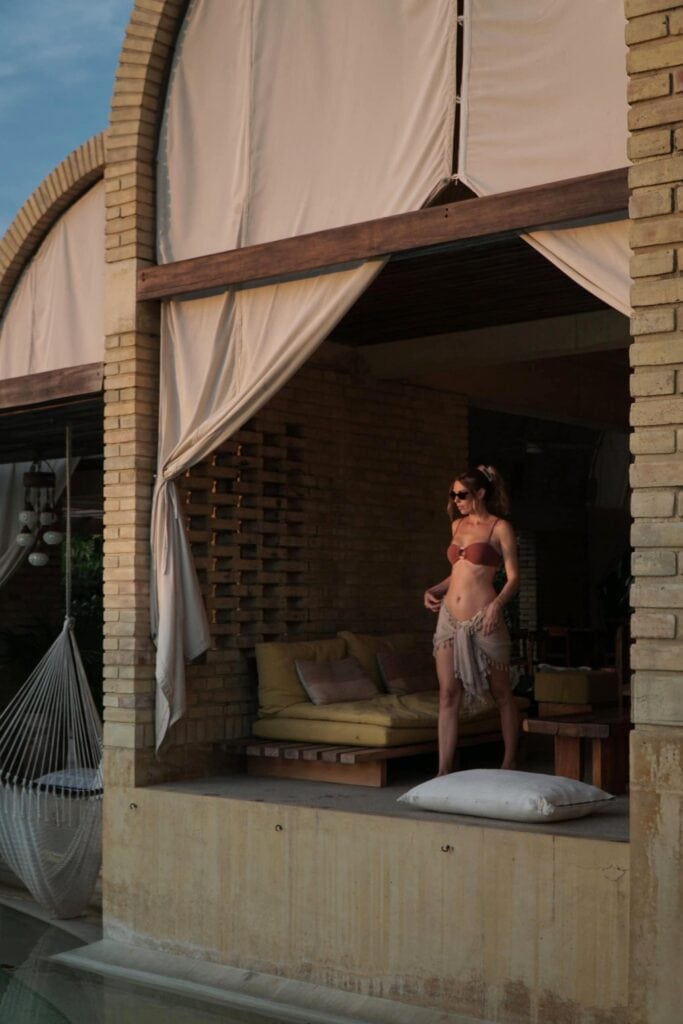 Lounging in a curtained brick vault suite during the Casona Sforza day pass