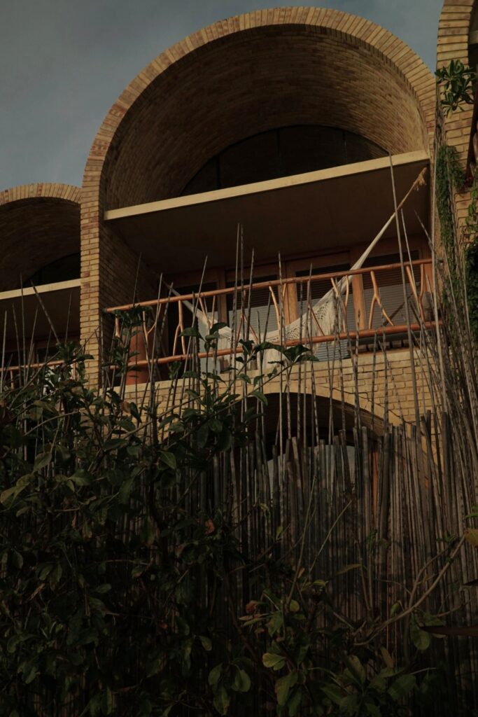 Suite balcony with a hammock under a brick vault at Casona Sforza
